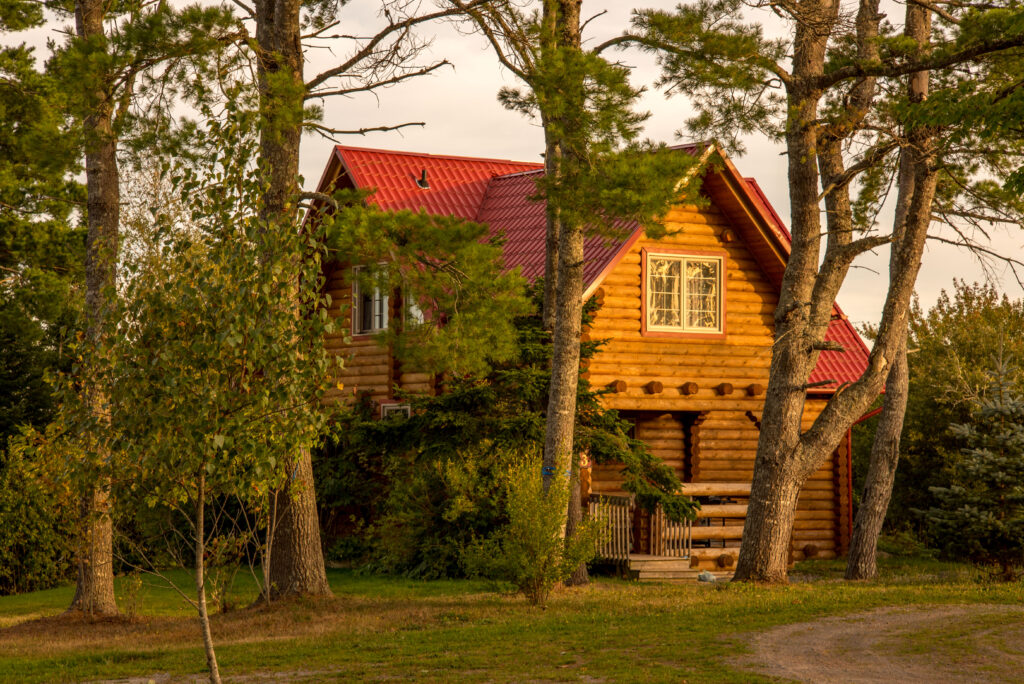 A two storey log cabin nestled among the trees at Tidal Bore Rafting Resort.