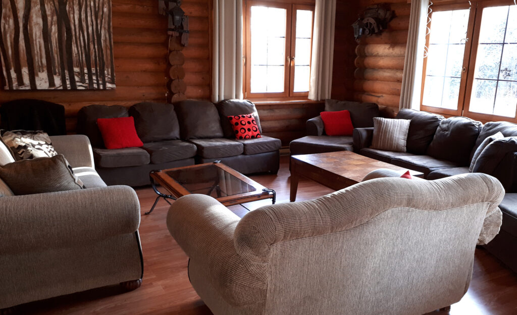 An image of the large living room in the Five Bedroom Log Cabin at Tidal Bore Rafting Resort.