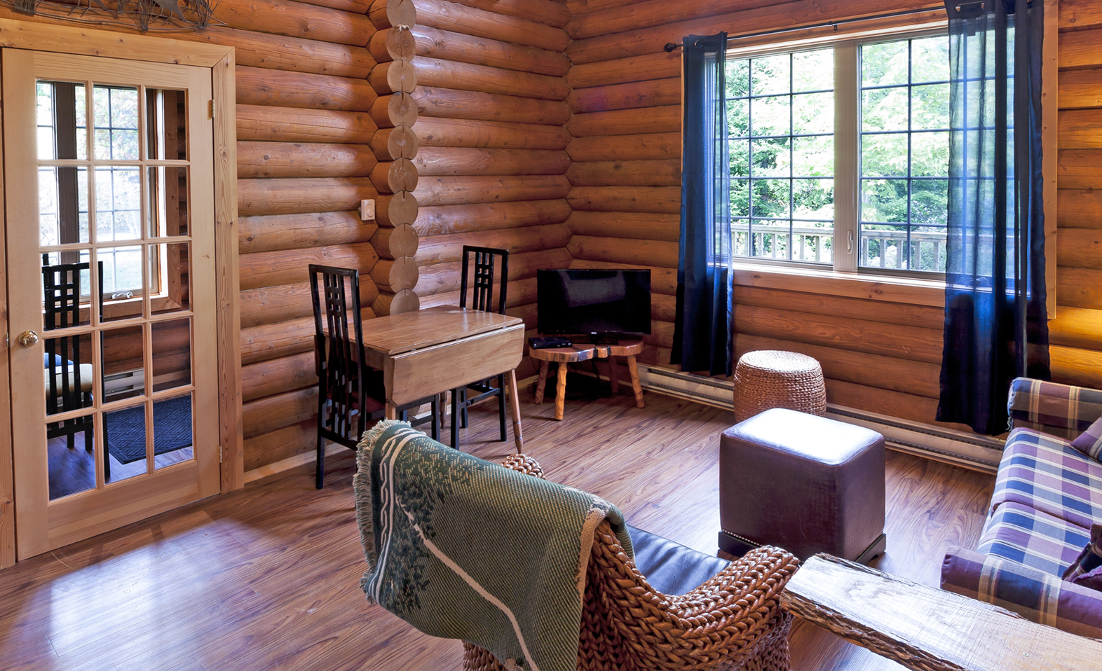 An image of the living room in the one storey log cabin at Tidal Bore Rafting Resort.