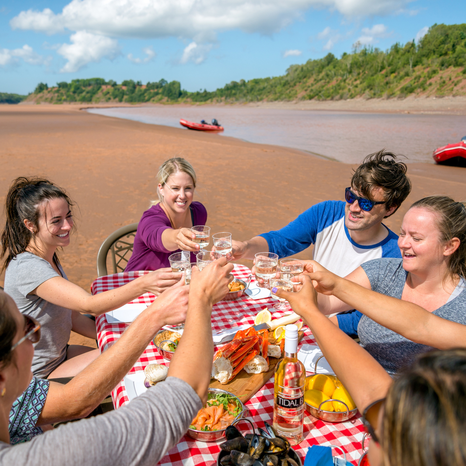 A group of rafters eating a seafood lunch on the sand bar before their tidal bore rafting tour.