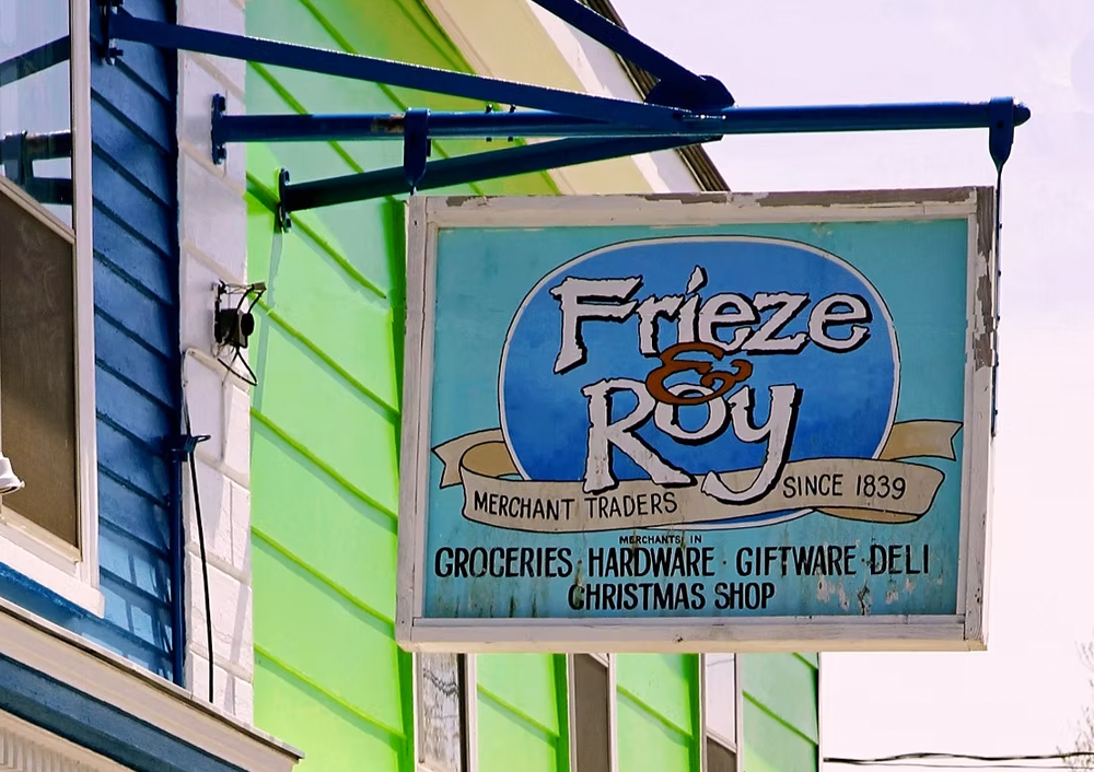 The weathered sign of Frieze & Roy general store in Maitland, Nova Scotia.