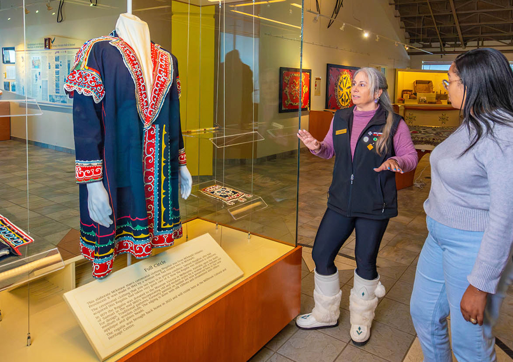 Heather Stevens explains the cultural significance of a piece of Mi'kmaq traditional regalia to a visitor at the Millbrook Cultural and Heritage Centre in Nova Scotia.